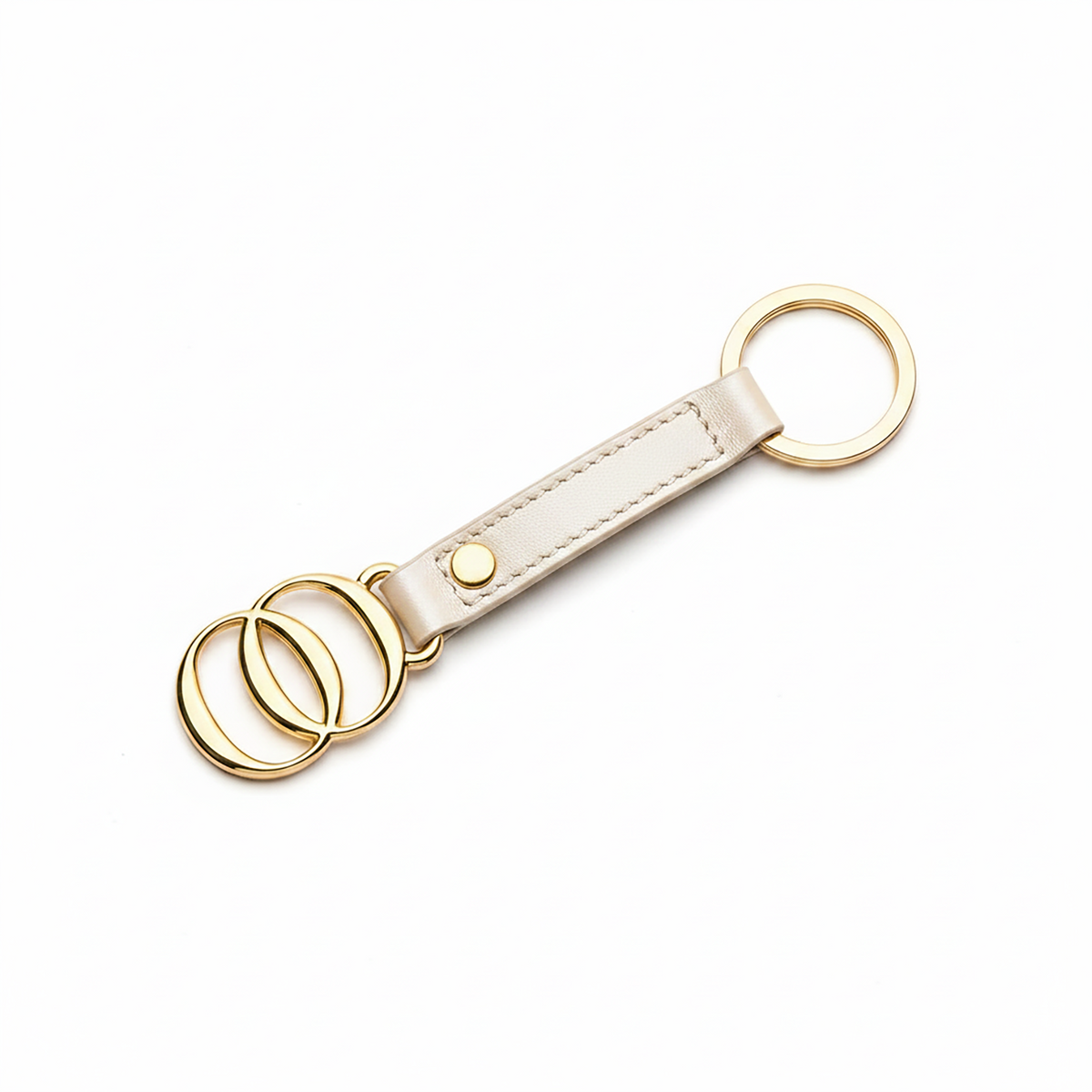 Portachiavi OROORO® in nappa color Oyster con finiture dorate su sfondo bianco